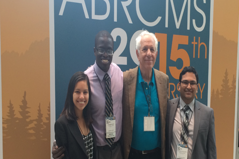 Students at a conference with Dr. Gaines.